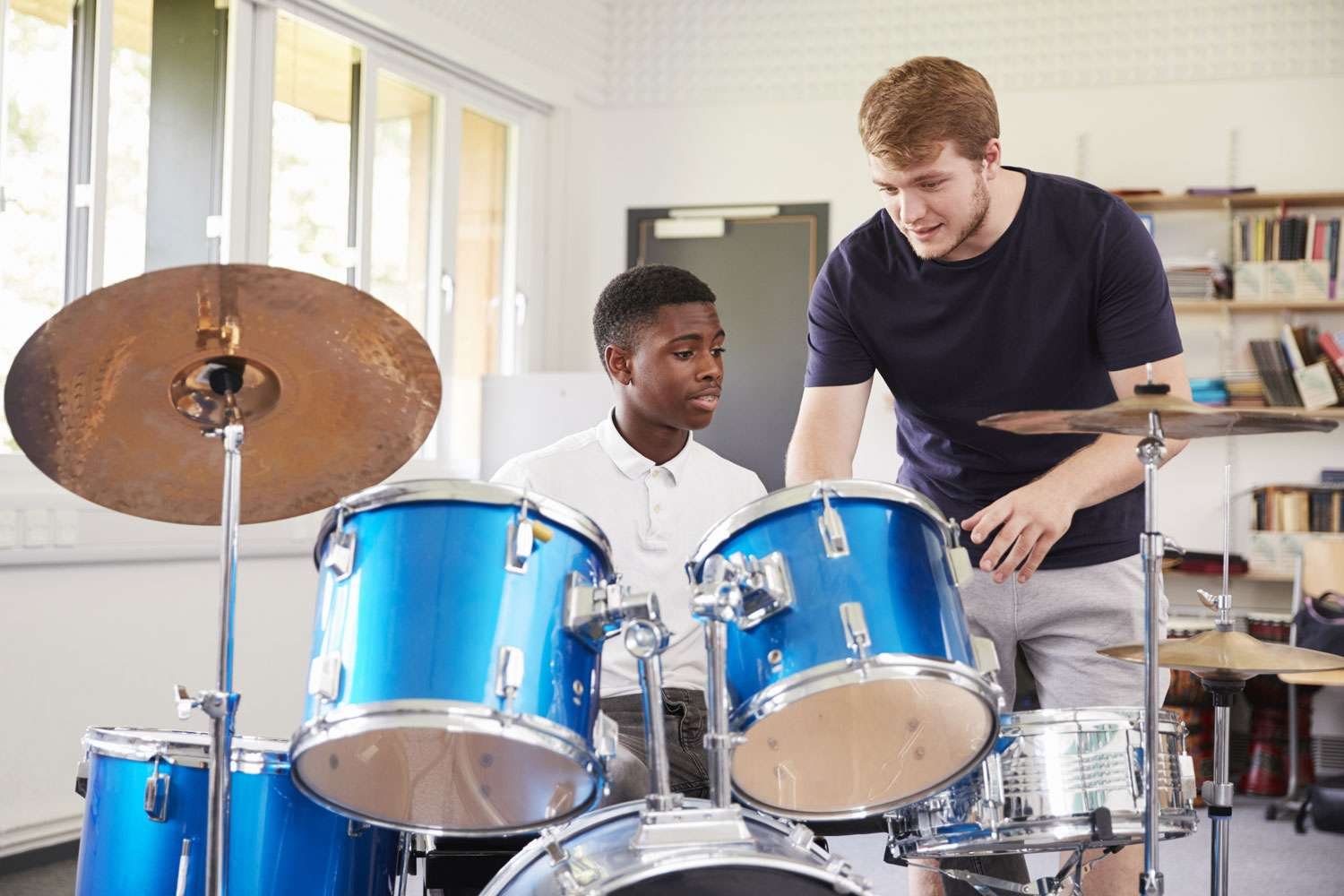 drum instructor with his student in a lesson