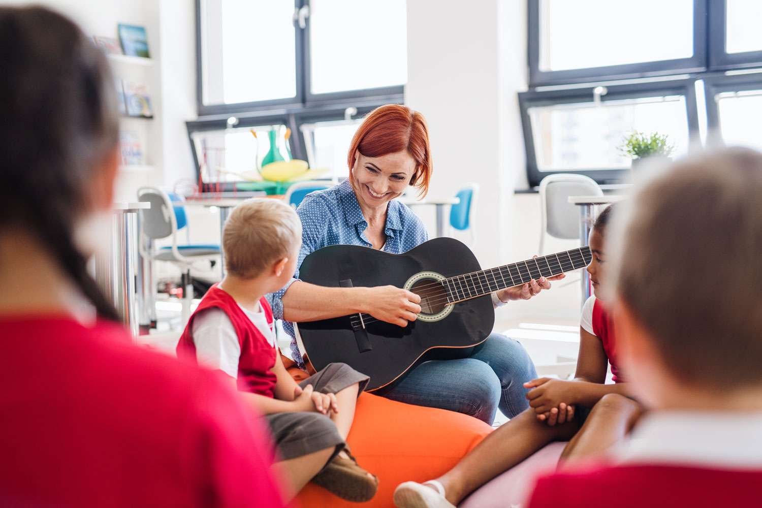 guitar instructor with her students