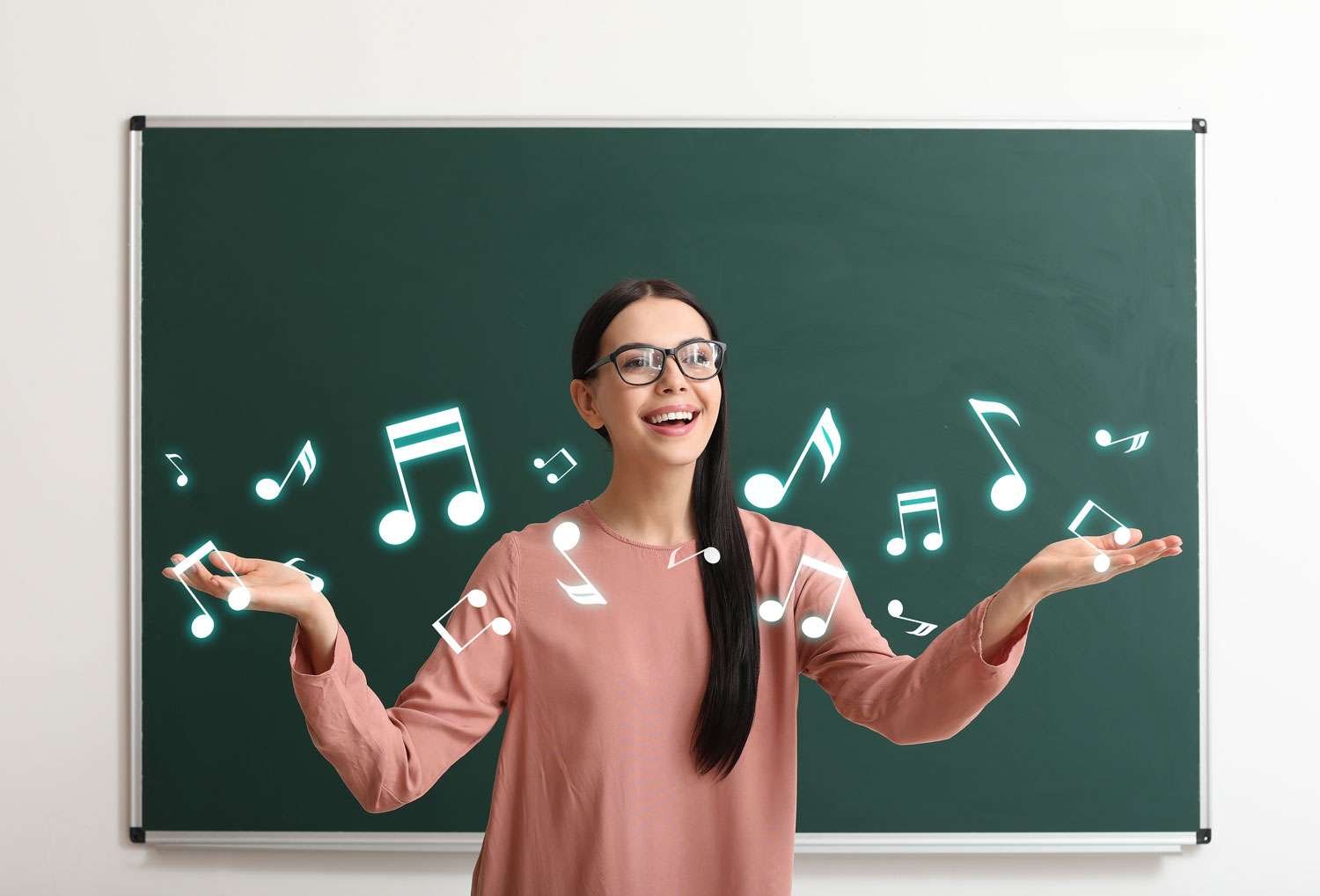 music instructor in front of chalkboard with musical notes floating in front of her