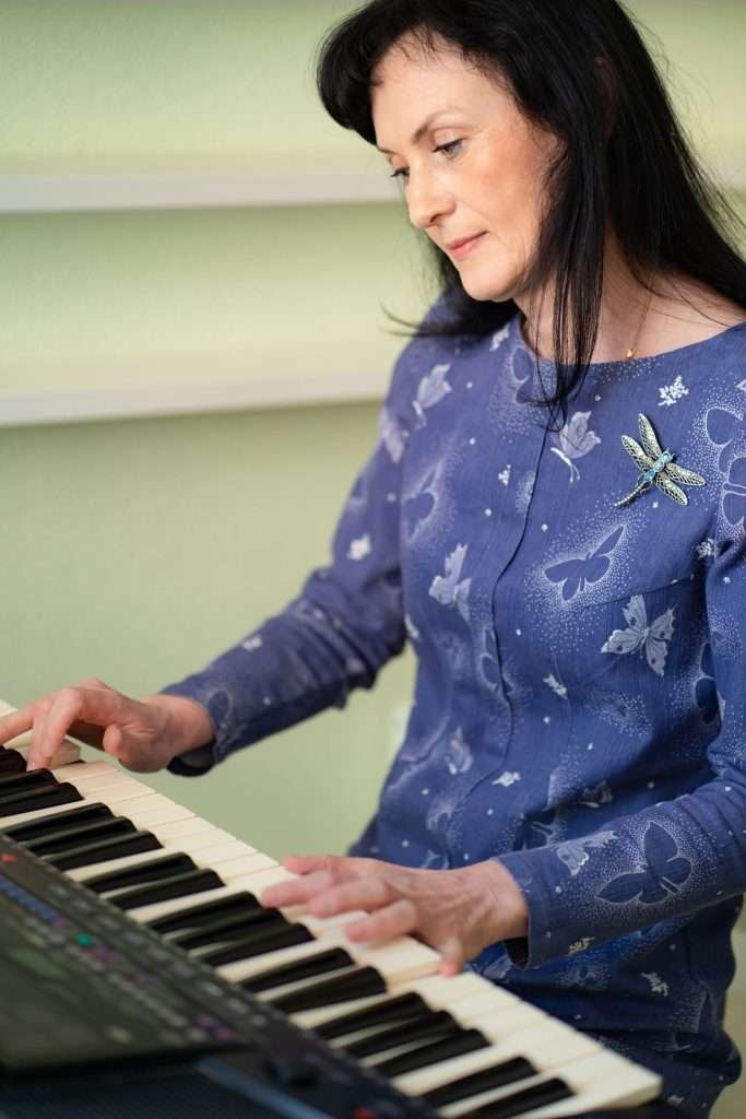 music instructor playing piano keyboard