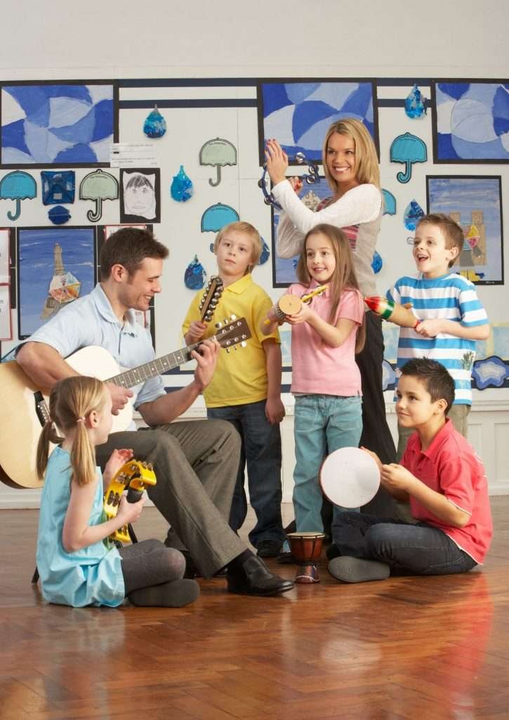 two adults and five children playing instruments