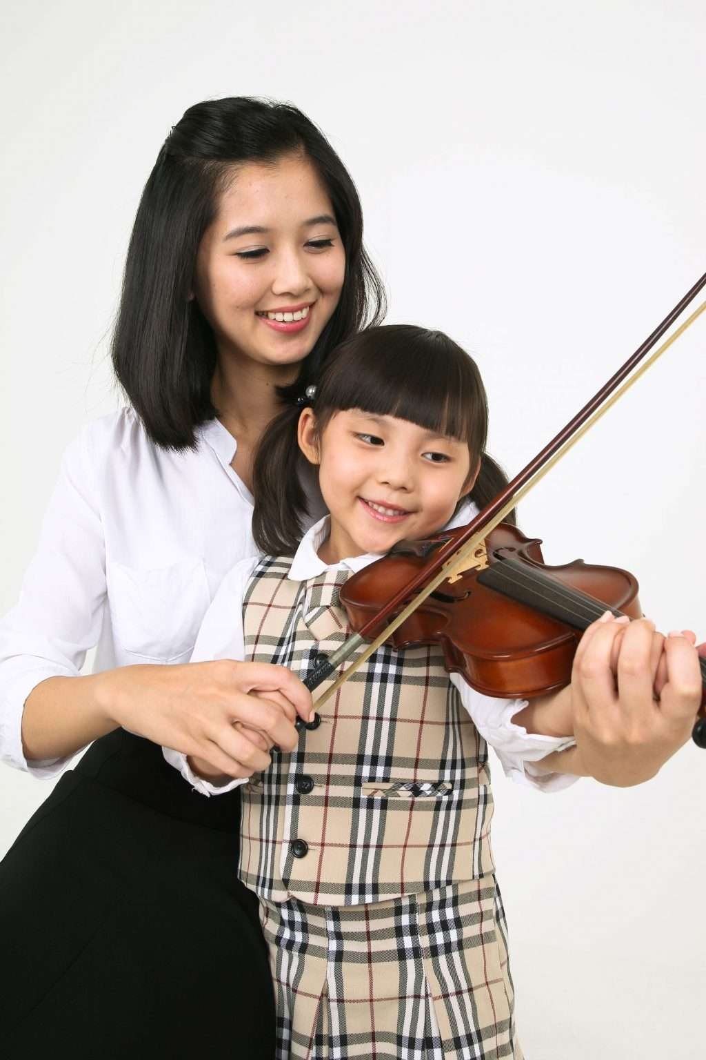 violin instructor with her young girl student