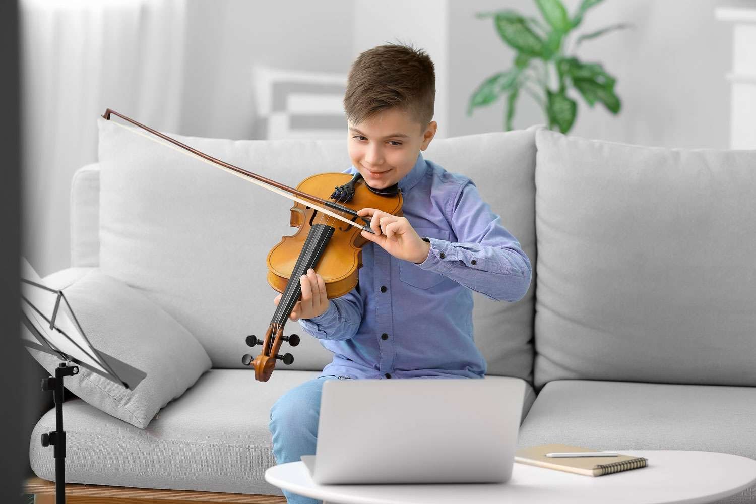 young boy having a violin lesson online