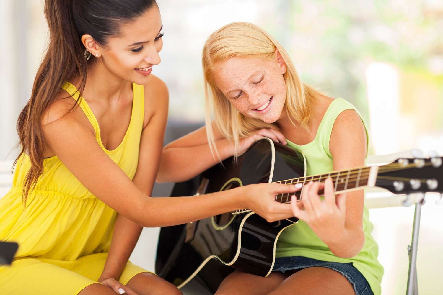 guitar lesson with a young instructor and her young girl student